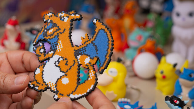Budokan Geek Convention In GUAYAQUIL, ECUADOR - 
OCT 13, 2024 - Close-up of a pixelated Charizard figure from Pok&eacute;mon, being held at a merchandise booth.