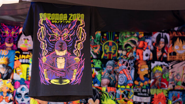 Budokan Geek Convention In GUAYAQUIL, ECUADOR - 
OCT 13, 2024 - A black t-shirt featuring Roronoa Zoro from One Piece anime, displayed at a merchandise stall at a geek convention.