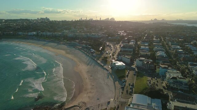 Aerial video of Bondi Beach at sunset with view of Sydney CBD skyline