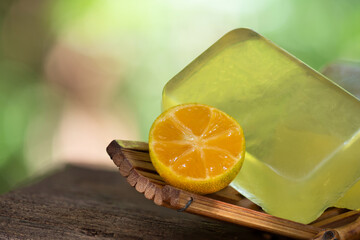 Glycerin soap mixed with kumquat extract and honey on natural background.