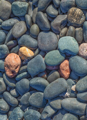 Rounded Red, Black, and Blue Beach Stones.