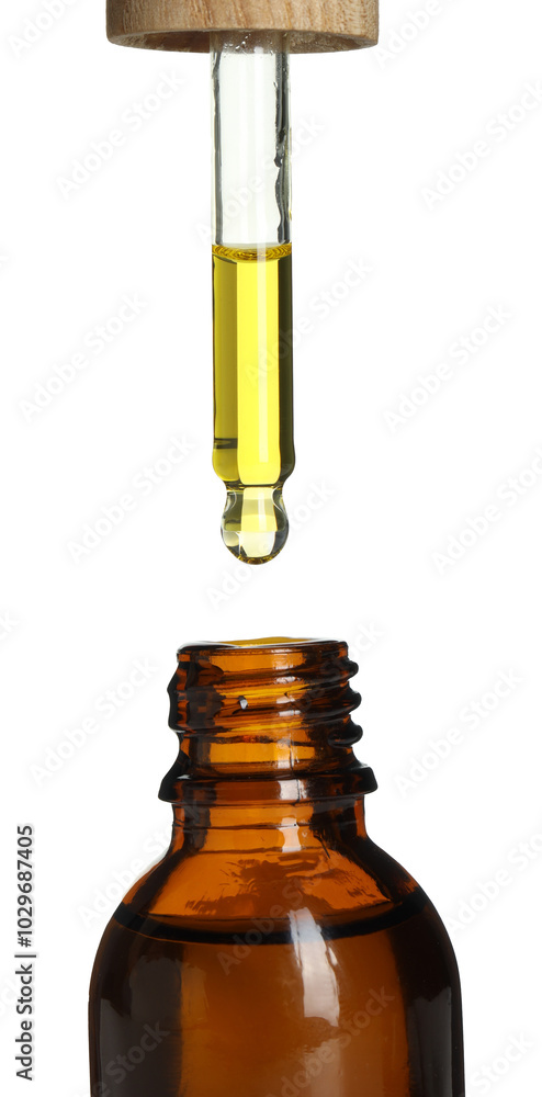 Wall mural Dripping tincture from pipette into bottle on white background, closeup