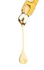 Cosmetic oil dripping from pipette on white background, closeup