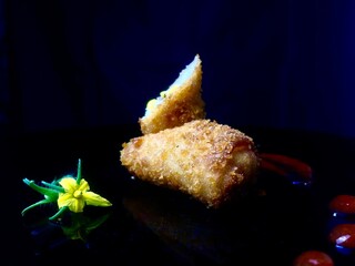 A delicious crispy fried roll with a garnish, perfect for a savory snack or appetizer.