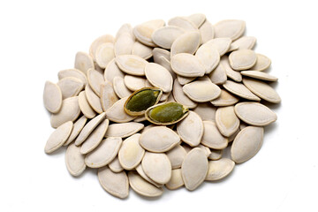 Roasted pumpkin seeds on white background.