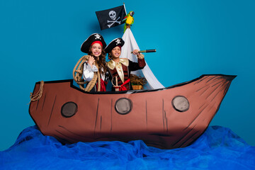 Full body photo of cute little boy girl discover have fun dressed pirates costumes float ship decor...