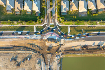 Industrial construction roadworks at roundabout intersection with moving cars in Venice, Florida....