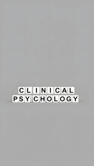 Fototapeta premium clinical psychology word or concept represented by black and white letter cubes on a grey horizon background stretching to infinity isolated with white highlights, png