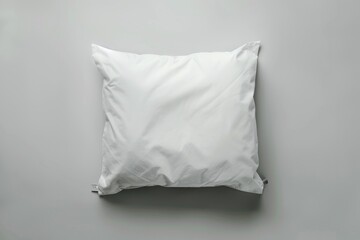 Obraz premium A white pillow with a tag on a grey background.