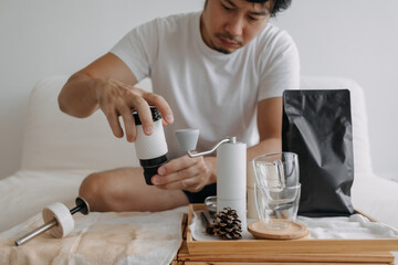 Step by step of Asian man making espresso with hand press tools.