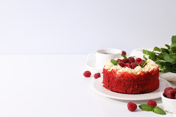 Red velvet cake, cup of tea, mint and berries on white background, space for text