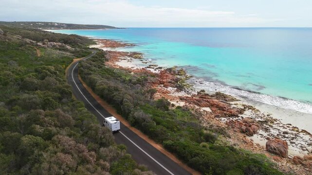 Drone flying over motorhome as it drives along scenic coastal road in Dunsborough, Western Australia