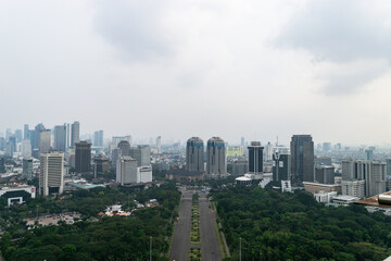 Fototapeta premium Modern skyscrapers towering over the skyline of jakarta, indonesia on a cloudy day