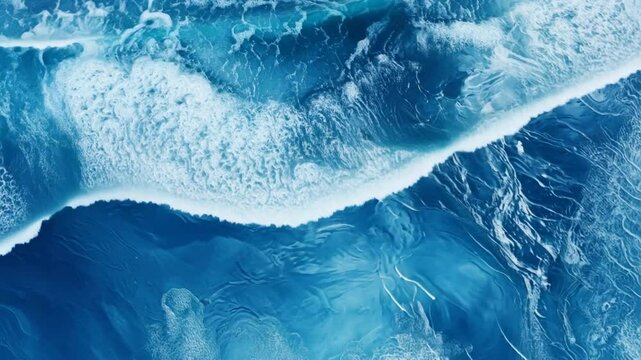 Ocean's Embrace: Aerial view of turquoise waves crashing, creating a mesmerizing abstract pattern of sea foam and deep blue water. A breathtaking display of nature's artistry. 
