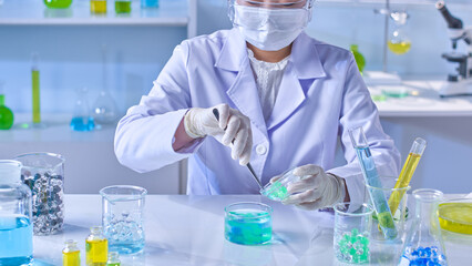 Laboratory scene photography with a female researcher is doing an experiment with hydrogel balls on...