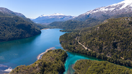 Obraz premium Aerial view of Los Alerces National Park, featuring the Arrayanes River footbridge and the stunning Lago Verde.