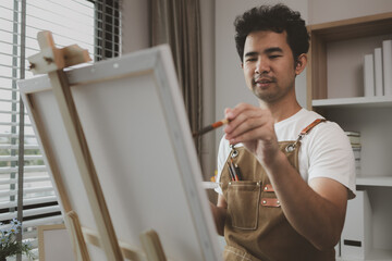 an artist is sitting in his own painting studio with his various painting tools, which is canvas,...
