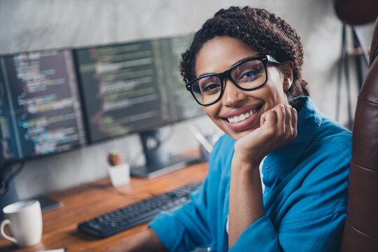 Photo of pretty young girl dreamy charming software engineer developer wear blue shirt coworking programmer successful nice light office