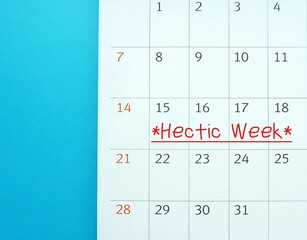 Calendar with handwriting HECTIC WEEK, means period packed with heavy workloads, busy schedule...