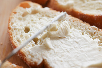  fresh butter spreading on a bread 