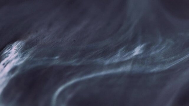 Ink glitter. Smoke cloud. Mystical paint art. Dark gray mixed white shiny particles texture liquid flow acrylic dark hypnotical waves.