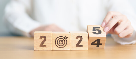 2024 year change to 2025 year block with dartboard icon. Goal, Target, Resolution, strategy, plan, Action, mission, motivation, and New Year start concepts