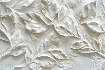  Elegant white textured wall relief art featuring delicate leaf patterns in plaster or concrete