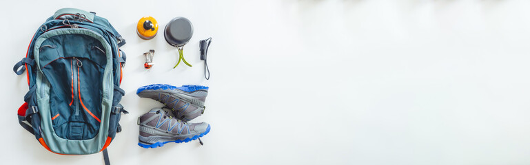 Hiking gear and camping equipment for travel on white backgroun. Web banner size.