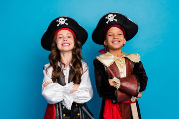 Photo of two small kids halloween pirate costume toothy smile crossed arms isolated on blue color...