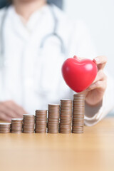 Money Saving, Health Insurance, Medical, Donation and Financial concepts. Doctor with coins stack...