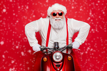 Close-up portrait of his he nice attractive cool bearded cheerful brutal virile Santa riding bike...