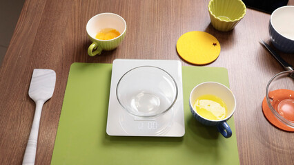 Process of preparing scales and dishes for dough preparation. Objects on wooden table. 