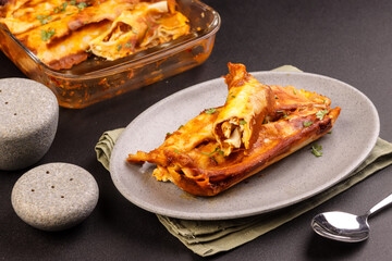 Chicken Enchiladas is Tortillas Stufed With Shredded Chicken and Top With Red Enchilada Sauce. 