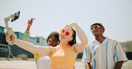 Friends, happy and live streaming with diversity for social media, content creation and holiday post in city. Group of people, memory and trendy style outdoor for influencer, fashion and gen z vlog