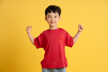 image of asian boy posing on yellow background