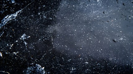 Obraz premium Polished black stone texture with sparkling surface for design applications