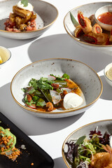 Vibrant Cuisine Smashed Cucumbers, Cashews, and Tofu on Minimalistic Plates in Natural Light