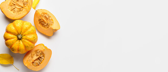 Fresh pumpkins and autumn leaves on white background