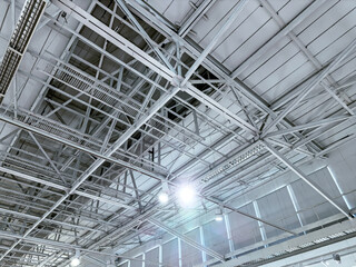 bottom view of industrial roofing with steel beams. roof of large modern storehouse.