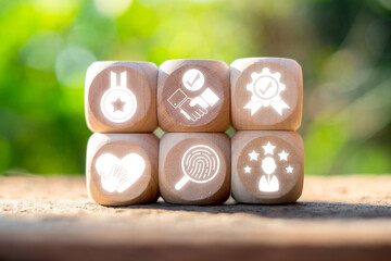 Wooden blocks with icons symbolizing trust, verification, and reliability, illustrating the concept...