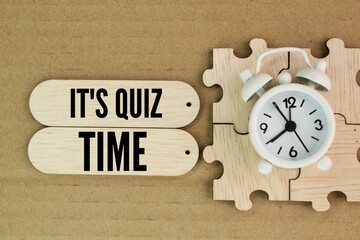 bell and clock stick with the words Its Quiz Time or it's quiz time. the concept of answering...