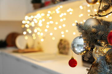 Christmas tree with balls in kitchen, closeup