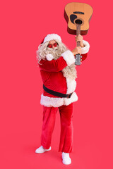 Santa Claus with guitar on red background
