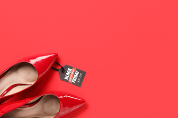 Pair of stylish high heeled shoes and tag with text BLACK FRIDAY SALE on red background