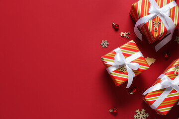 Christmas gift boxes with decor on red background