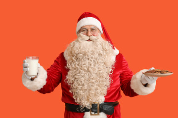 Santa Claus with glass of milk and tasty cookies on orange background