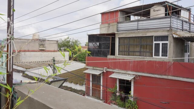Red abandoned house windows doors terrace clouds cloudy clouds vegetation rooftops roof poor poverty underdeveloped country alone nobody isolation loneliness ugly documentary documentation Mexico