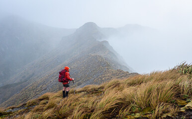 Man standing on a cloudy mountain in New Zealand