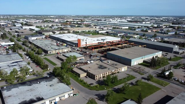 Aerial shot of warehouses in Calgary with rusty equipment.