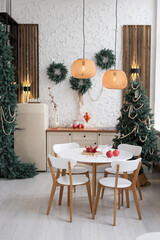 A festive dining space with elegant decorations, greenery, and warm lighting perfect for holiday gatherings and cozy meals at home